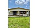 Cozy single-story home with a covered front porch, black railings, and a well-maintained lawn at 5330 Jo St, Zephyrhills, FL 33542