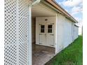 View of an outdoor storage shed with double doors and lattice siding at 5330 Jo St, Zephyrhills, FL 33542