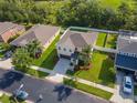 Spacious property with lush green lawn, a driveway and mature trees in a desirable neighborhood at 5446 Suncatcher Dr, Wesley Chapel, FL 33545