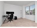 Bright bedroom with plush carpeting, a large window, and a desk area for work or study at 5446 Suncatcher Dr, Wesley Chapel, FL 33545