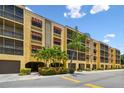Low rise condominium building with covered parking and a tropically landscaped entrance at 5817 Park N St # 310, St Petersburg, FL 33709