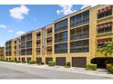 Condominium building featuring convenient garage parking and colorful tropical landscaping at 5817 Park N St # 310, St Petersburg, FL 33709