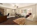 Comfortable living room with a large window, cozy seating, and a functional desk area at 5960 Boyette Rd, Wesley Chapel, FL 33545