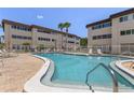 Sparkling community pool offers a refreshing escape with ample lounging space and palm tree accents at 6370 1St N St # 202, St Petersburg, FL 33702