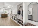Stylish entryway with built-in shelving, modern mirror, and light wood flooring at 6618 12Th N St, St Petersburg, FL 33702