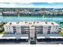 Aerial view of a condo building with covered parking, showcasing its location near a body of water at 7625 Sun Island S Dr # 304, South Pasadena, FL 33707