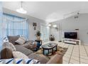 Spacious living room featuring a comfortable couch, stylish rug, and bright natural light at 8208 Volusia Pl, Tampa, FL 33637