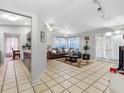 Open-concept living space with tile flooring, neutral walls, and seamless flow to the kitchen at 8208 Volusia Pl, Tampa, FL 33637