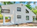 Home exterior showcasing a balcony, modern windows, and a bright, updated design at 8521 N 29Th St, Tampa, FL 33604