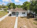 Inviting single-story home with a quaint front porch and detached garage at 914 E North St, Tampa, FL 33604