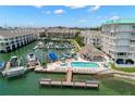 Stunning aerial view of waterfront community featuring boat docks, swimming pool, and beautiful landscaping at 9201 Captiva Cir, St Pete Beach, FL 33706