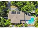 Aerial view of the home's roof, solar panels, backyard pool, and mature landscaping at 925 Monticello N Blvd, St Petersburg, FL 33703