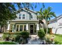 Two-story home featuring a welcoming front porch, manicured landscaping, and a classic facade at 925 Monticello N Blvd, St Petersburg, FL 33703