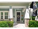 Inviting front porch with stylish seating, elegant columns, and a charming entryway at 925 Monticello N Blvd, St Petersburg, FL 33703