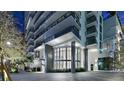 Modern condo building at night featuring sleek architecture and manicured landscaping at 100 1St N Ave # 2703, St Petersburg, FL 33701