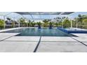 The gorgeous backyard pool features a screened enclosure, fountains, and a blue tiled spa at 1028 Signet Dr, Apollo Beach, FL 33572