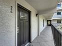 Condo exterior view featuring a dark front door with sidelight and balcony with black metal railing at 105 4Th Ne Ave # 426, St Petersburg, FL 33701