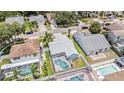 Aerial view of home with screened-in pool, fenced yard, and well-maintained landscaping at 11222 Clayridge Dr, Tampa, FL 33635