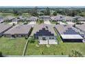 Aerial view of the house highlighting its solar panels on the roof and spacious backyard within a community at 146 Rain Berry Ave, Ruskin, FL 33570