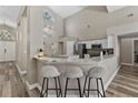 Bright kitchen with white cabinets, granite countertops, and a stylish breakfast bar with seating at 18017 Palm Breeze Dr, Tampa, FL 33647
