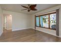 Sunlit living room with wood-look flooring and a large window offering pleasant outdoor views at 2010 Bayview Pl, Indian Rocks Beach, FL 33785