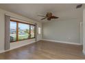 Spacious living area with a ceiling fan, natural light, and wood-look flooring at 2010 Bayview Pl, Indian Rocks Beach, FL 33785