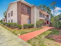 View of an apartment building featuring a second-story balcony and brick accents at 21032 Voyager Blvd # 8, Land O Lakes, FL 34638