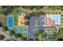 Bird's eye view showcasing community amenities including a pool, tennis court, basketball court, and playground at 2350 126Th E Dr, Parrish, FL 34219