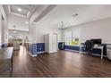 Bright living room with hardwood floors, white trim, and a work space near the window at 2350 126Th E Dr, Parrish, FL 34219