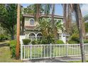 Beautiful home exterior with lush landscaping and a charming white picket fence at 2616 11Th N St, St Petersburg, FL 33704