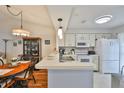 Spacious kitchen with a breakfast bar, white cabinetry, and stainless steel appliances at 311 Knottwood Ct, Sun City Center, FL 33573
