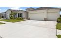 Long driveway leading to a well-maintained home with a three-car garage at 33700 Hamilton Hill Ln, Wesley Chapel, FL 33545