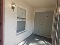 Close-up of the entryway to the home with window and storage area at 3455 Countryside Blvd # 33, Clearwater, FL 33761