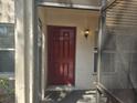 Close-up of an inviting townhouse front door and outdoor lighting at 3455 Countryside Blvd # 33, Clearwater, FL 33761