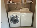 Complete laundry area with modern appliances and shelving for organizing supplies at 3455 Countryside Blvd # 33, Clearwater, FL 33761