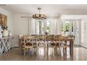 Bright dining room features a rustic table set for eight, neutral decor, and large windows at 3691 Center Cir, Largo, FL 33774