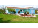 Well-manicured front lawn complements the quaint home with its charming curb appeal and inviting entrance at 3839 Star Island Dr, Holiday, FL 34691