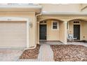 Welcoming front entrance with covered porch and brick walkway to the front door at 3922 Silverlake Way, Wesley Chapel, FL 33544