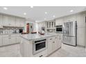 Bright kitchen featuring a large center island with stainless steel microwave and modern appliances at 4049 Wellington Pkwy, Palm Harbor, FL 34685
