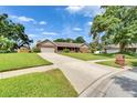 Single-story brick home with attached garage and a neatly maintained front lawn at 414 Summit Chase Dr, Valrico, FL 33594