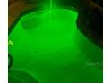 Inviting pool with illuminated by vivid green underwater lights and convenient step access at 4500 Onorio St, New Port Richey, FL 34653