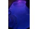 Inviting pool with illuminated by vivid purple underwater lights and convenient step access at 4500 Onorio St, New Port Richey, FL 34653