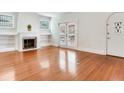 Bright living room with hardwood floors, decorative fireplace, and access to the backyard at 4521 W Azeele St, Tampa, FL 33609