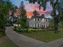A beautiful two-story house with an expansive lawn, mature trees, long driveway, and exquisite landscaping at 4611 Ackerly Way, Brandon, FL 33511