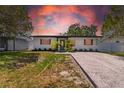 Charming one-story home with updated exterior, lush landscaping, and a newly graveled driveway at 4684 72 N Ave, Pinellas Park, FL 33781