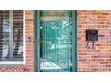 Close-up of the home's ornate glass-paneled front door and a mailbox on the brick facade at 4915 Chariton Ave, Tampa, FL 33603