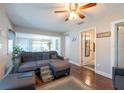 Inviting living room featuring hardwood floors, comfortable seating, and an open layout to the dining area at 5106 15Th S Ave, Gulfport, FL 33707