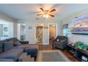 Cozy living room with hardwood floors, ceiling fan, comfortable seating, and bright natural light at 5106 15Th S Ave, Gulfport, FL 33707