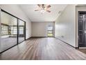 Bright living room featuring wood-look floors, ceiling fan and access to sunroom at 5115 Stonehaven Ct, Tampa, FL 33624