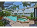 Relaxing screened-in pool and spa area overlooking the canal, perfect for outdoor entertainment and tranquility at 5417 Tybee Island Dr, Apollo Beach, FL 33572